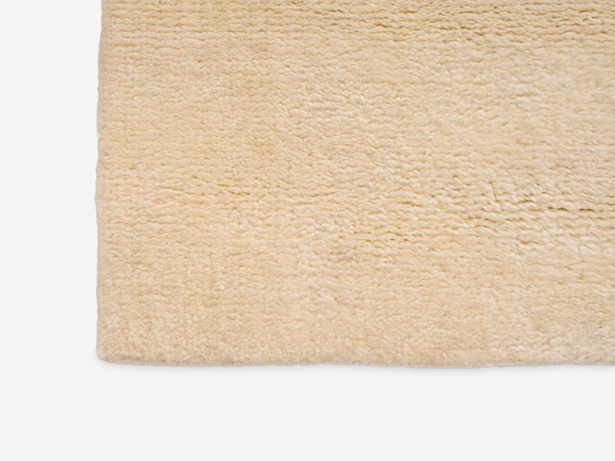 Detail view of large plush beige area rug